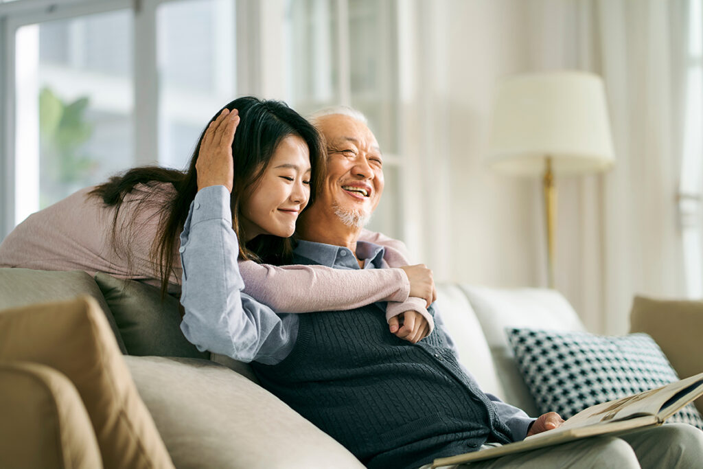 daughter hugging parent after learning about helping aging parents with finances