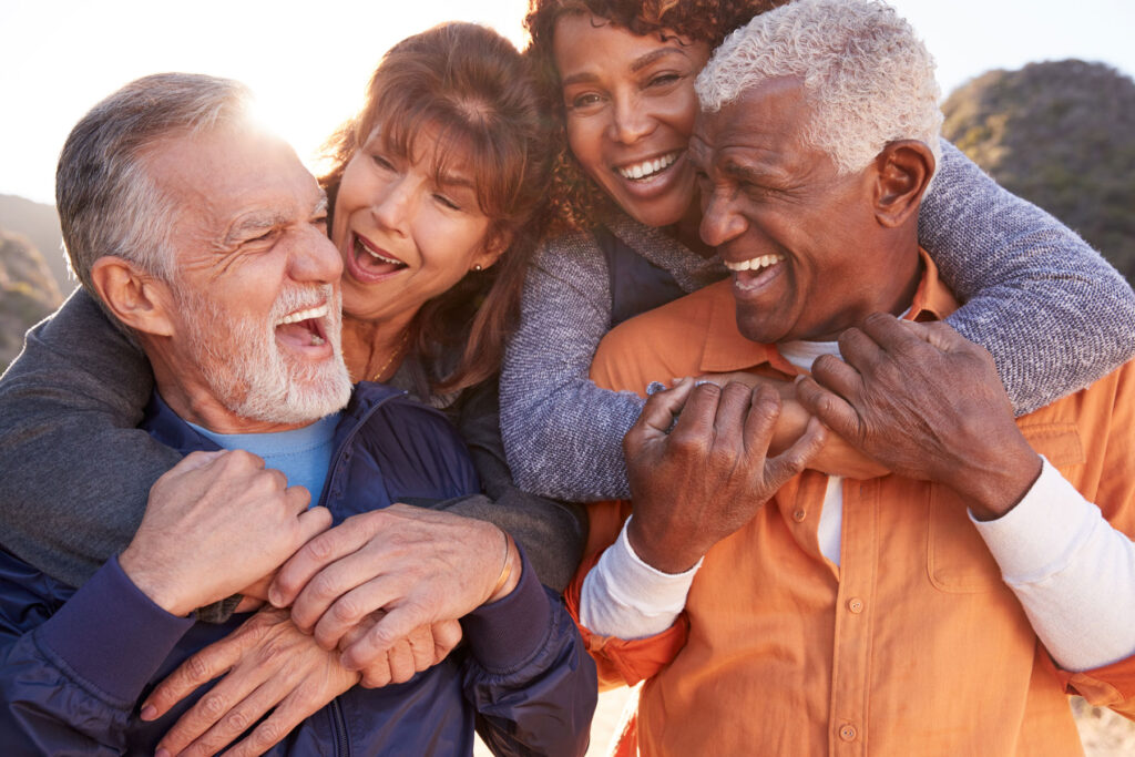 senior friends smiling and laughing while enjoying outdoor time
