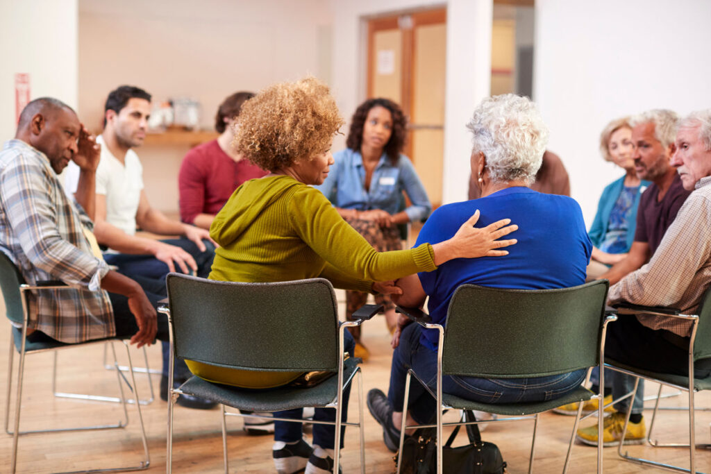 people comforting one another in caregiver support groups