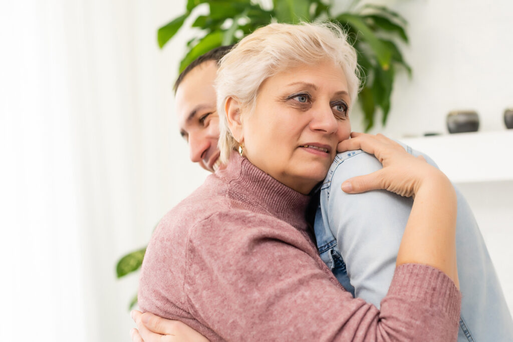 Senior woman hugging man