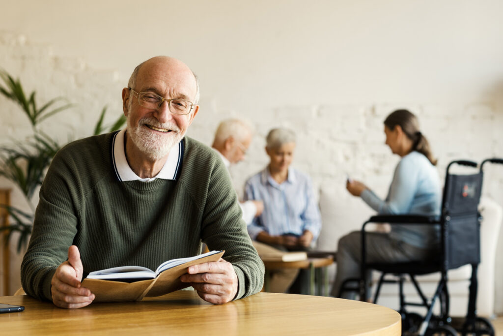 Senior man smiling at table