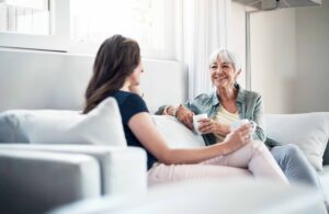 a senior woman has a visit with her daughter in senior living