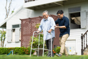 person helping man with walker after overcoming caregiver guilt