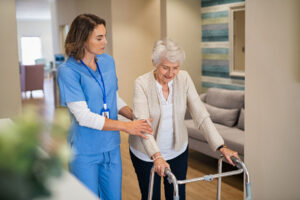 person helping woman with walker as part of assisted living fall prevention