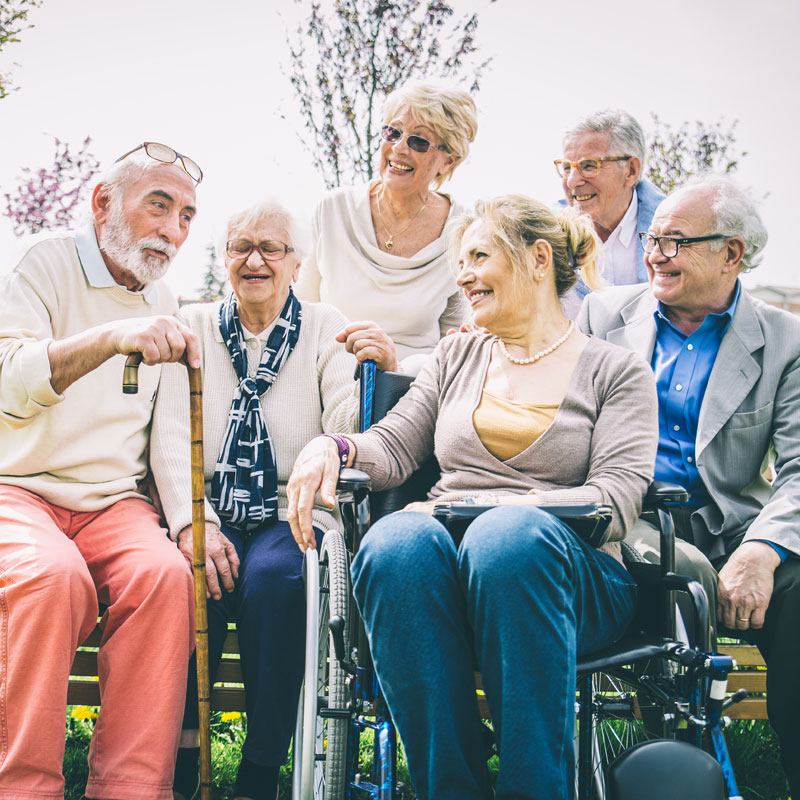 a senior friend group gathers for a photo outside