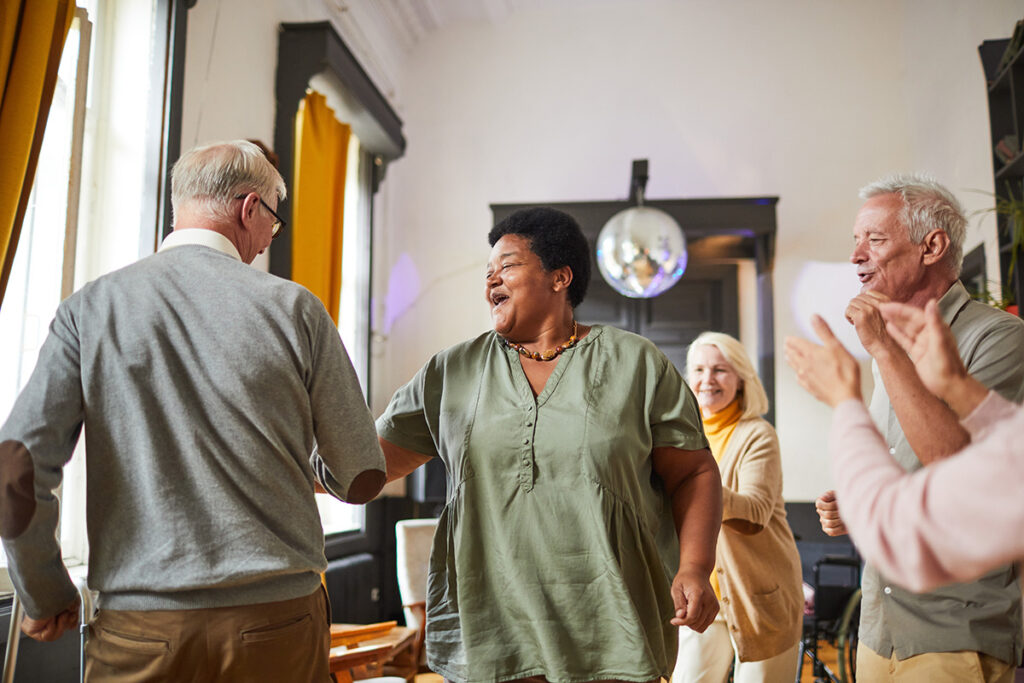 senior friends meet for a dance party in assisted living