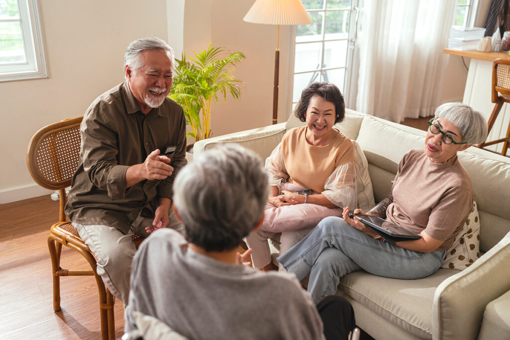 a senior couple has friends to visit their assisted living community