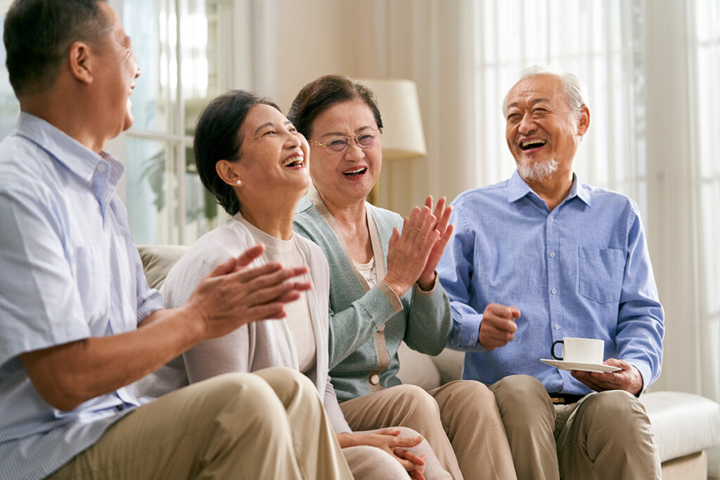 a senior couple enjoys the company of loved ones in assisted living