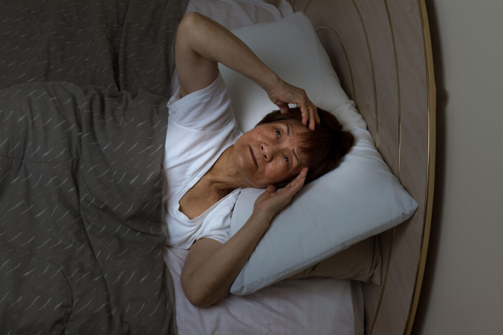 person in bed experiencing sundowning