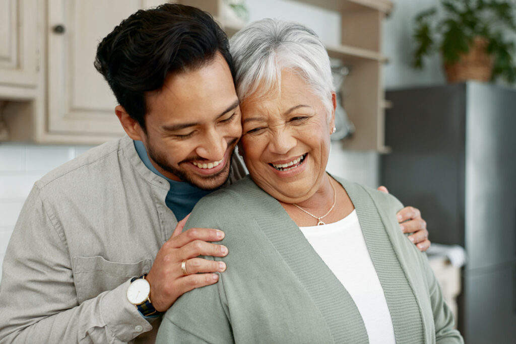 Man laughing with senior mother
