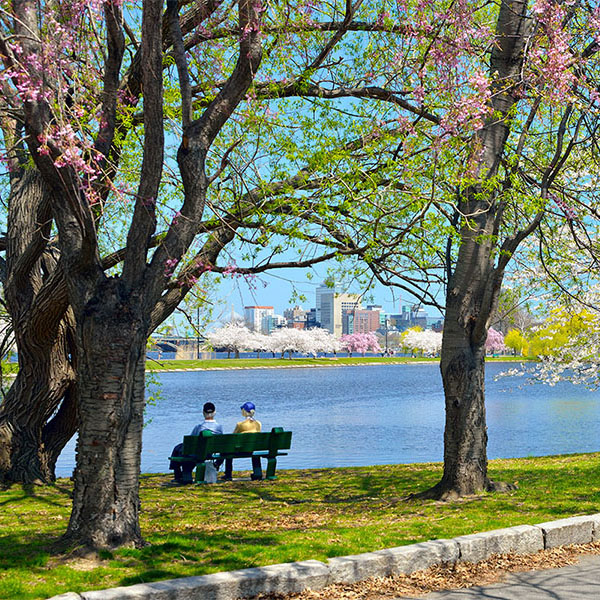 Seniors on bench next to water in Massachusetts
